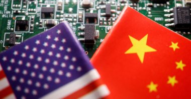 The flags of China and the U.S. are displayed on a printed circuit board with semiconductor chips, in this illustration picture taken Feb. 17, 2023. (Reuters Photo)