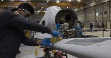 An employee work on wind turbine blade production in Izmir, western Türkiye, July 4, 2023. (AA Photo)