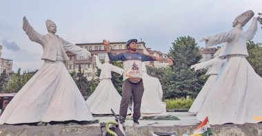 Fayis Asraf Ali posing with statues of sufis in Konya, Türkiye, July 5, 2023. (Photo by Fayis Asraf)