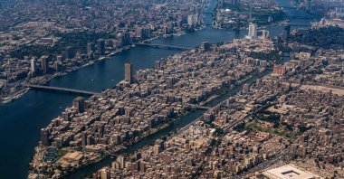 An aerial view of the historic Mosque of Amr ibn al-Aas (bottom R) in the Fustat and Coptic Cairo district and the Nile island district of Manial al-Roda (C), with Cairo's twin-city of Giza across the river, Cairo, Egypt, April 28, 2023  (AFP Photo)