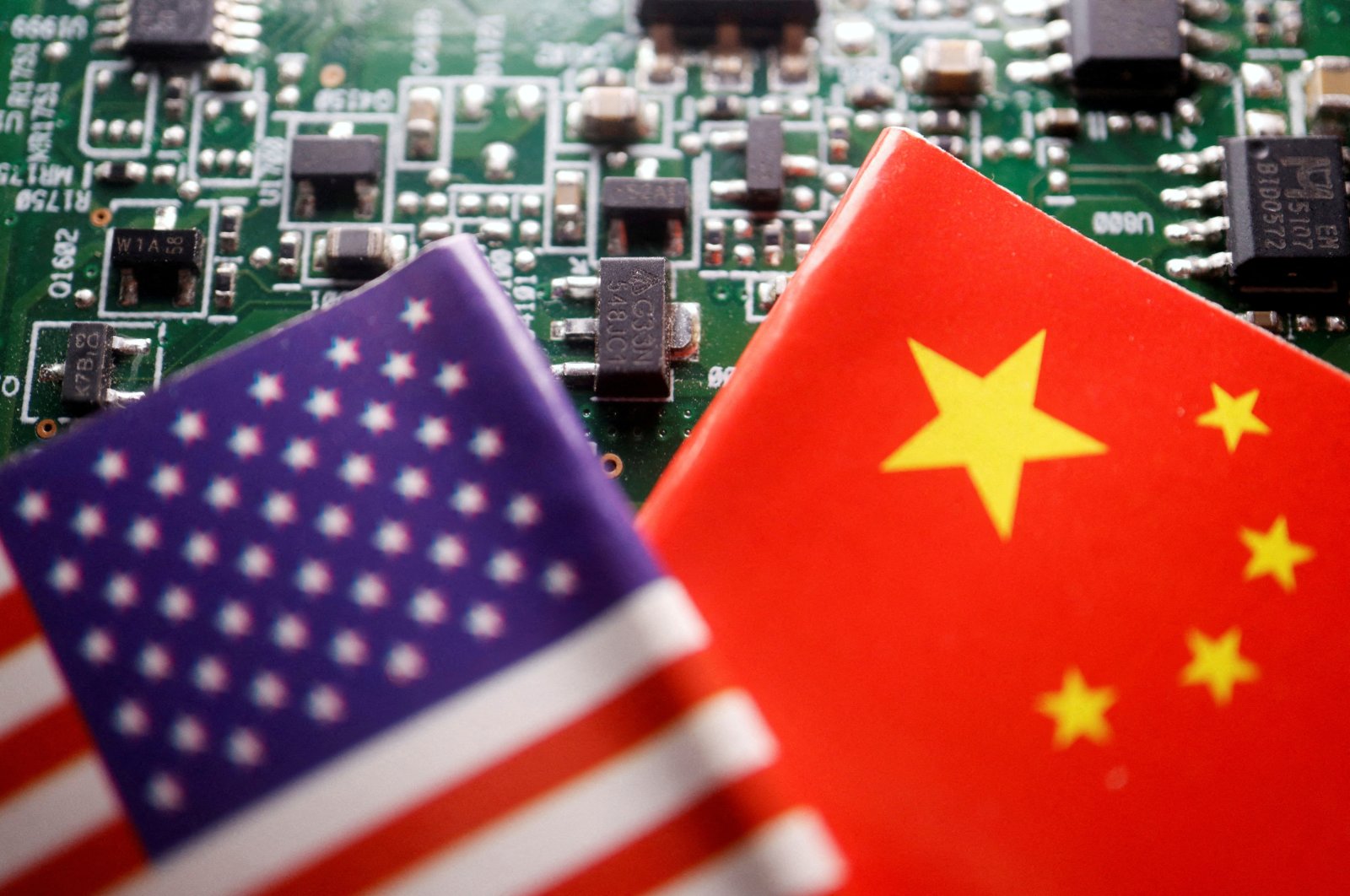 The flags of China and the U.S. are displayed on a printed circuit board with semiconductor chips, in this illustration picture taken Feb. 17, 2023. (Reuters Photo)