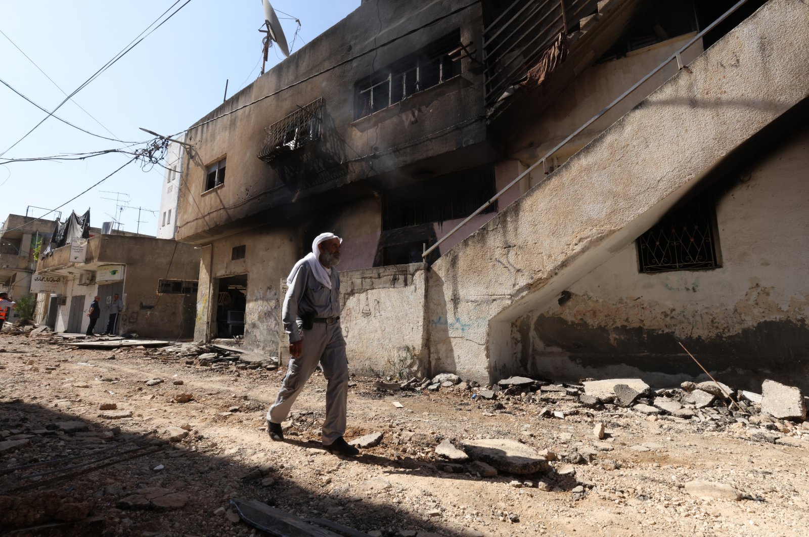 A man walks next to a damaged building after the Israeli army raid in the West Bank city of Jenin, Palestine, July 5, 2023. (EPA Photo)
