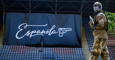A volunteer of the Espanola special force unit, a detachment of Russian football hooligans, guards the football stadium, Mariupol, Ukraine, June 22, 2023. (AFP Photo)