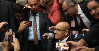 Treasury and Finance Minister Mehmet Şimşek is surrounded by journalists after making a statement during the group meeting of ruling Justice and Development Party (AK Party) at the Turkish Grand National Assembly in Ankara, Türkiye, June 21, 2023. (AFP Photo)