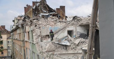 A rescuer works at an apartment building partially destroyed by a missile strike, Lviv, Ukraine, July 6, 2023. (AFP Photo)