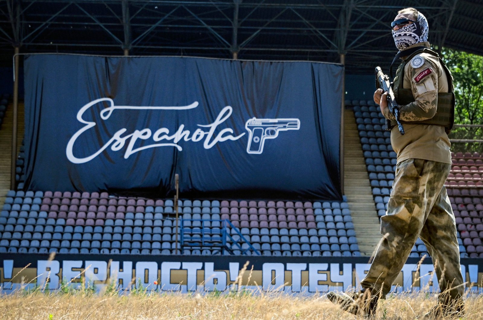 A volunteer of the Espanola special force unit, a detachment of Russian football hooligans, guards the football stadium, Mariupol, Ukraine, June 22, 2023. (AFP Photo)