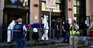 Members of the police evacuate the body of a victim after a fire killed six people at a retirement home, Milan, Italy July 7, 2023. (AFP Photo)