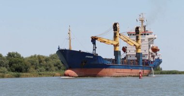 A Cargo ship sails through Bystre rivermouth, which connects the Black Sea and the Danube, at a location given as Izmail district of Odessa region, Ukraine in this screen grab obtained from a handout video released on July 15, 2022. (Reuters Photo)