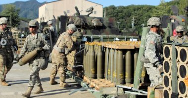 Soldiers draw 155mm Base Burn Dual Purpose Improved Conventional Munition rounds and carry them into their vehicles during a load exercise, undisclosed location, July 7, 2023. (AFP Photo / DVIDS)