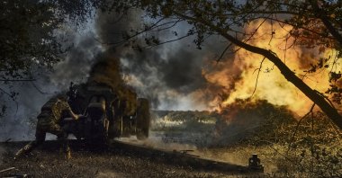 A Ukrainian policeman of special police unit fires a D-30 cannon towards Russian positions at the front line, near Kreminna, Luhansk region, Ukraine, July 7, 2023. (AP Photo)
