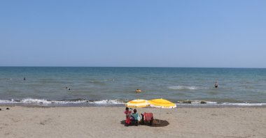 Citizens enjoying the sunny day at a beach in the coastal region of the Black Sea, Türkiye, July 9, 2023. (DHA Photo)