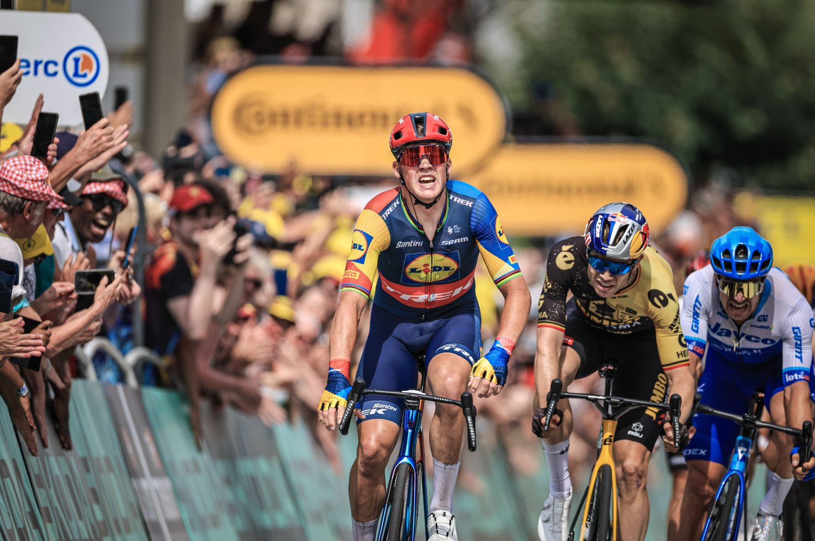 Danish rider Mads Pedersen of team Lidl-Trek (C) crosses the finish line to win the 8th stage of the Tour de France 2023, a 201km race from Libourne to Limoges, France, July 8, 2023. (EPA Photo)