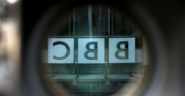 A BBC logo is reflected in the viewfinder of a television camera outside the British Broadcasting Corporation (BBC) headquarters in London, U.K., March 13, 2023. (Reuters Photo)