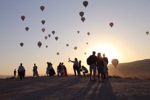 Tourists enjoying the view of the sky dotted with hot air balloons, Capadoccia, central Türkiye, July 6, 2023. (AA Photo)