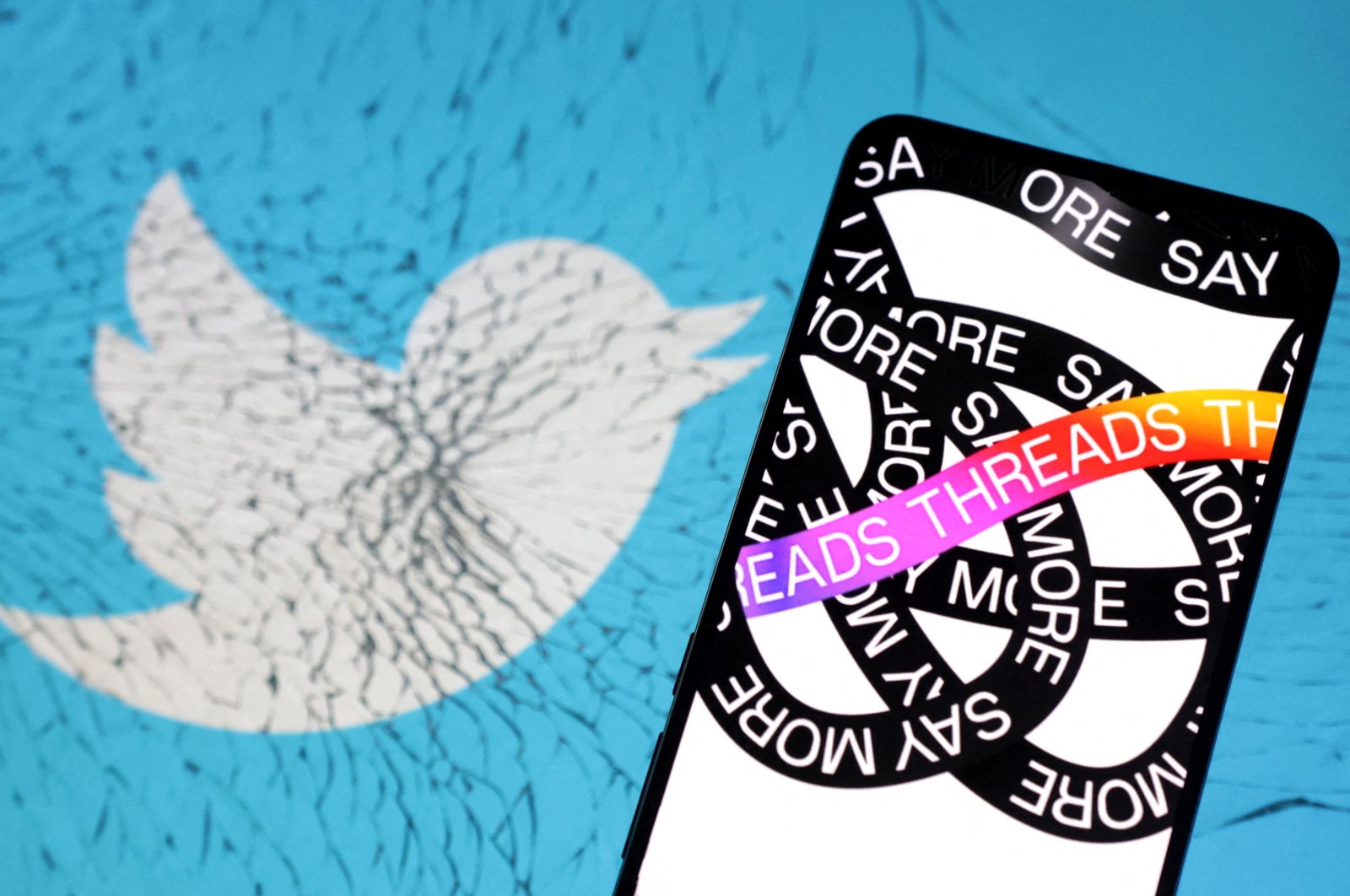 Meta Threads app logo is placed on cracked Twitter app logo in this illustration from July 7, 2023. (Reuters Photo)