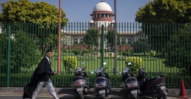 A lawyer walks inside the Supreme Court premises, in New Delhi, India, Oct. 13, 2022. (AP Photo)