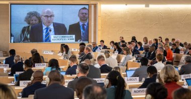 U.N. High Commissioner for Human Rights Volker Turk (C) is seen on a giant screen as he delivers a speech at the opening of the 53rd U.N. Human Rights Council in Geneva, on June 19, 2023. (AFP File Photo)