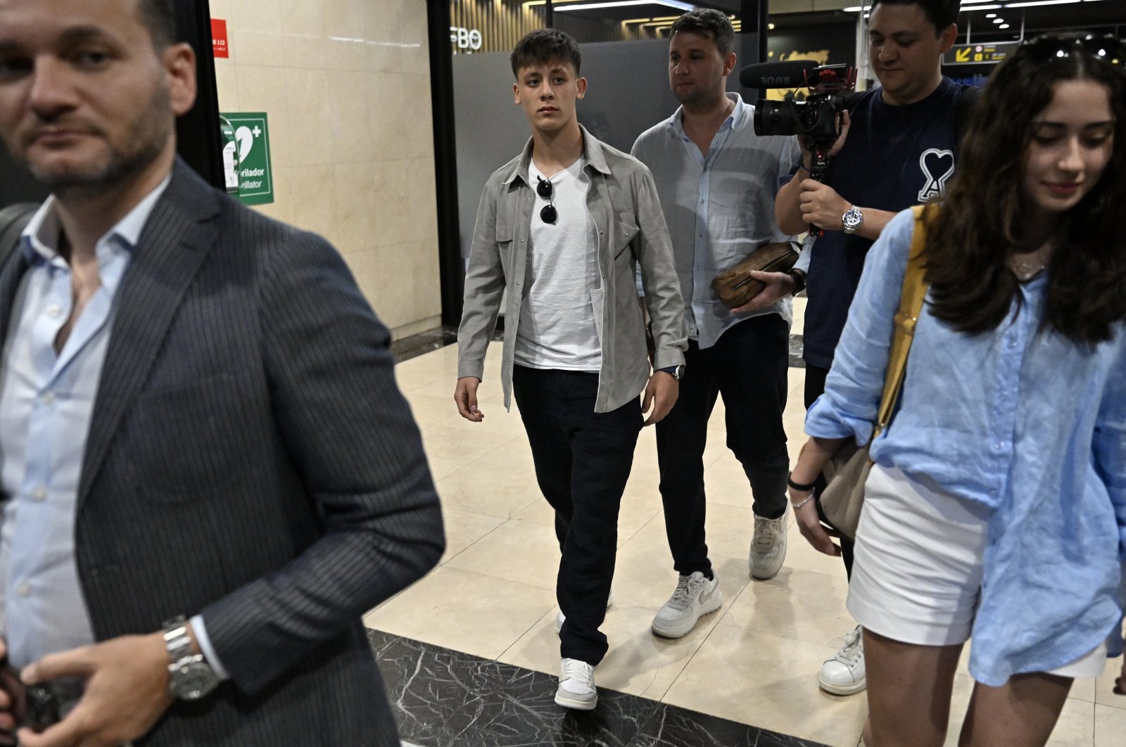 Real Madrid&#039;s Arda Güler (C) arrives at the Barajas Adolfo Suarez with his entourage ahead of his unveiling, Madrid, Spain, July 7, 2023. (AA Photo)