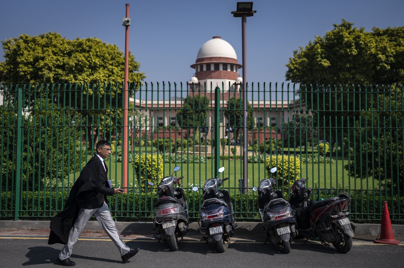 A lawyer walks inside the Supreme Court premises, in New Delhi, India, Oct. 13, 2022. (AP Photo)