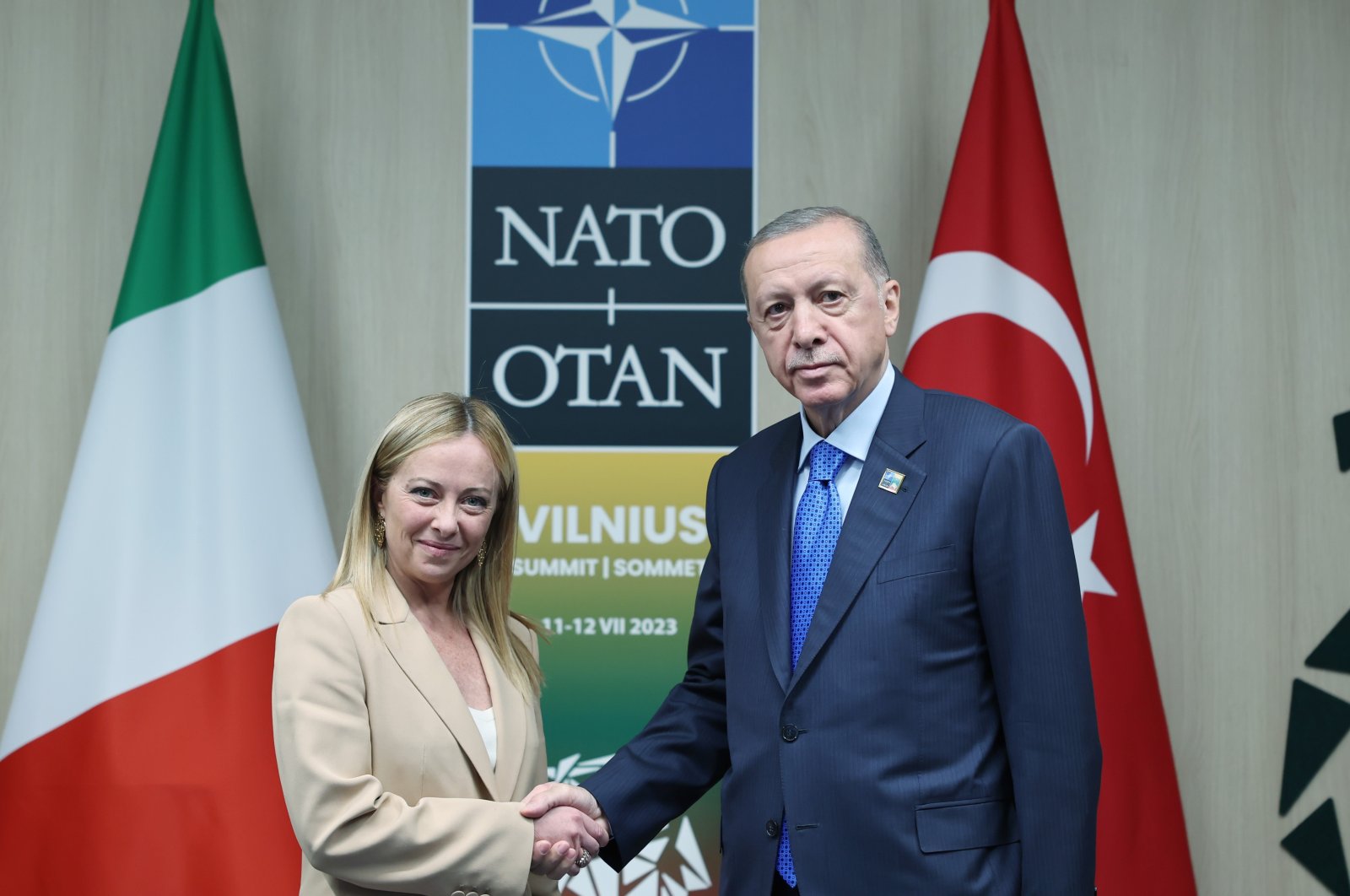 President Recep Tayyip Erdoğan (R), Italian Prime Minister Giorgia Meloni shake hands on sidelines of NATO summit in Vilnius, Lithuania, July 11, 2023. (AA Photo)