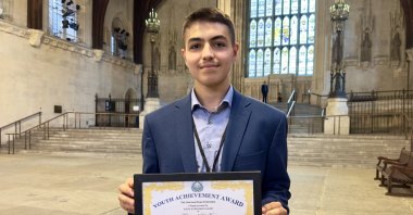 Sixteen-year-old Muhammed Safa Kaya poses with his award presented by the U.N.'s Universal Peace Federation (UPF) for outstanding leadership performance, Watford, U.K., July 12, 2023. (AA Photo)