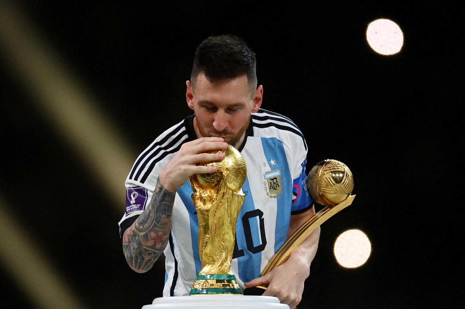 Argentina&#039;s Lionel Messi kisses the World Cup trophy after receiving the Golden Ball award as he celebrates after winning the World Cup final against France at the Lusail Stadium, Lusail, Qatar, Dec. 18, 2022. (Reuters Photo)
