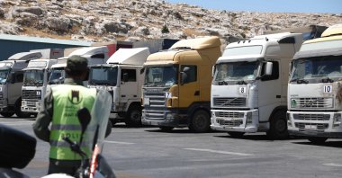 A convoy of trucks carrying humanitarian aid is seen parked after crossing the Syrian Bab al-Hawa border crossing with Türkiye, July 10, 2023. (AFP Photo)