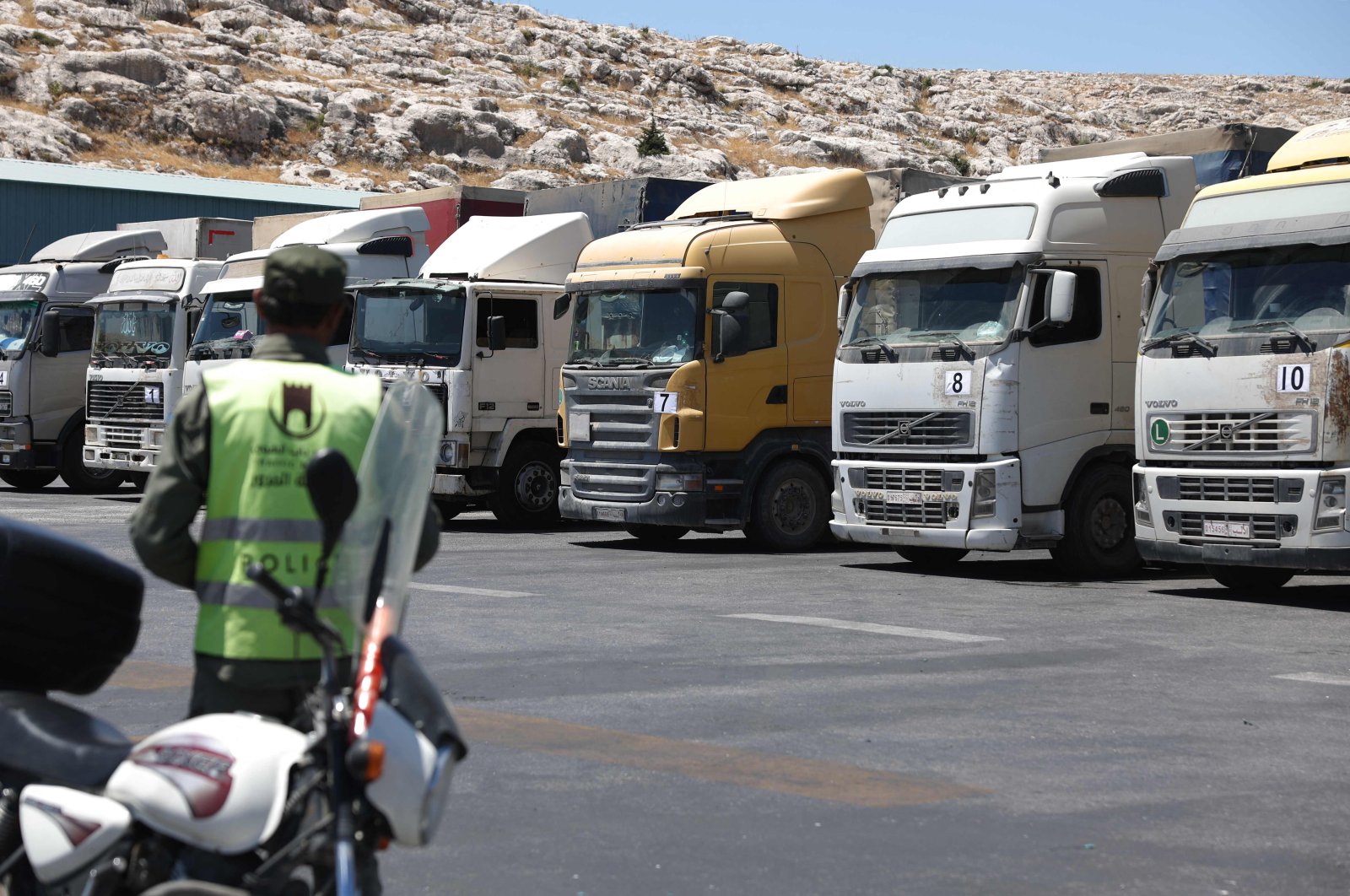 A convoy of trucks carrying humanitarian aid is seen parked after crossing the Syrian Bab al-Hawa border crossing with Türkiye, July 10, 2023. (AFP Photo)