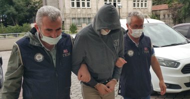 Police escort a FETÖ suspect captured in an operation in Denizli, western Türkiye, March 20, 2023. (İHA Photo)