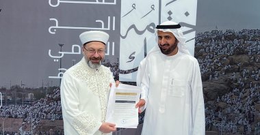 Tawfiq bin Fawzan Al Rabiah (R), Saudi Arabia's minister of Hajj and Umrah, presents the award to the head of the Presidency of Religious Affairs in Türkiye Ali Erbaş, Mecca, Saudi Arabia, July 1, 2023. (AA Photo)