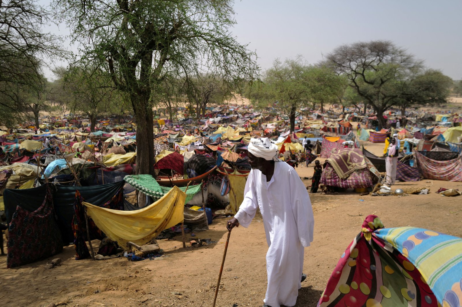 A Sudanese men who fled the conflict in Sudan&#039;s Darfur region walks past makeshift shelters near Borota, Chad, May 13, 2023. (Reuters Photo)