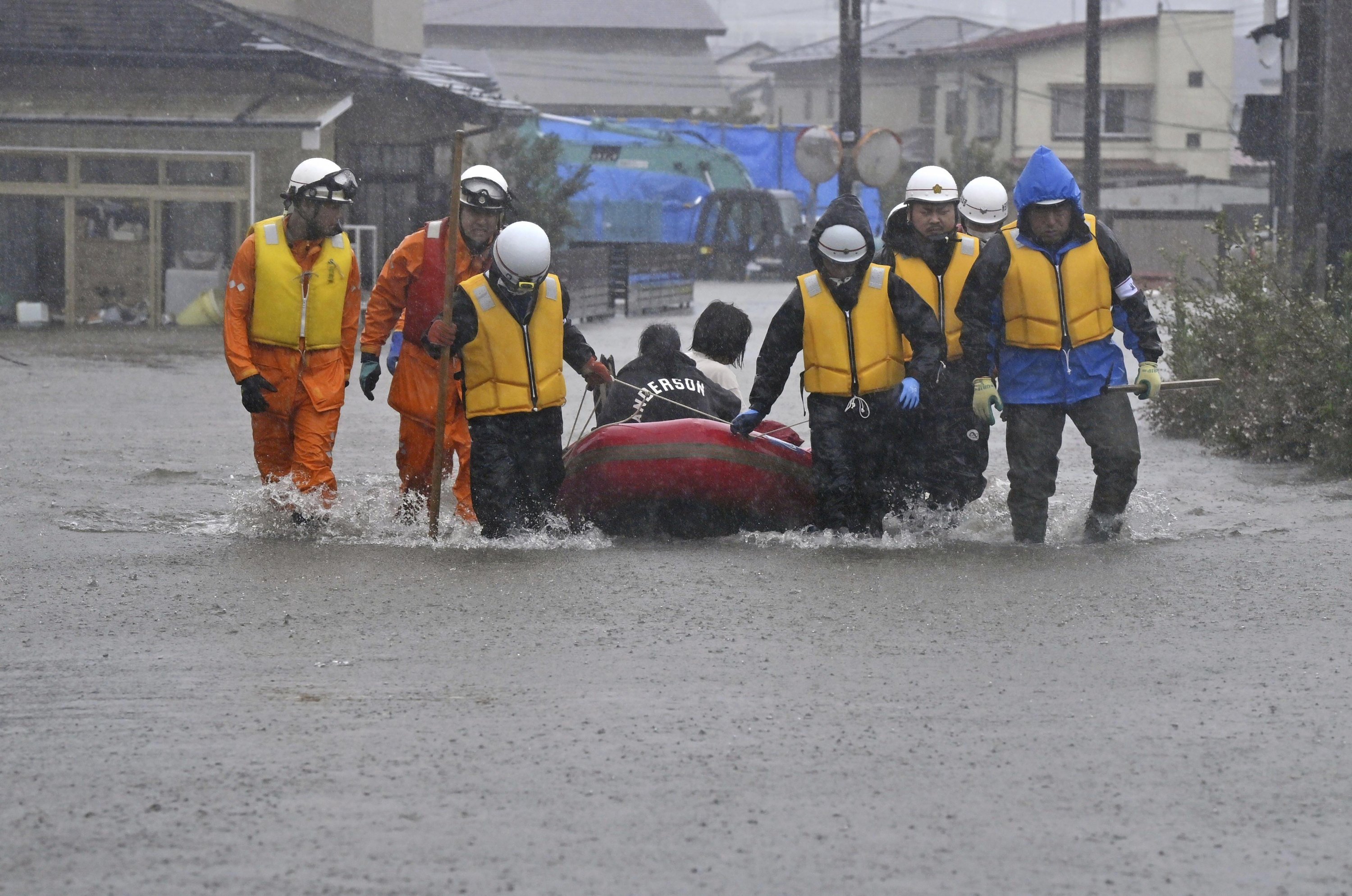 Orang-orang dipindahkan dengan perahu karena daerah pemukiman terendam banjir akibat hujan lebat di Akita, Jepang utara, 15 Juli 2023. (Foto AP)