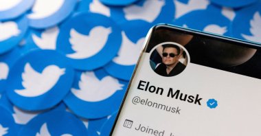 Elon Musk&#039;s Twitter profile is seen on a smartphone placed on printed Twitter logos in this picture illustration taken April 28, 2022. (Reuters Photo)