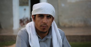 Ahmad Muhammad al-Hasan poses for a picture during an interview with Anadolu Agency (AA) in the garden of his home in Tel Abyad, Syria, July 14, 2023. (AA Photo)