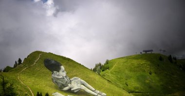 One of the two Diptych giant biodegradable land-art paintings entitled &quot;The sun has an appointment with the moon&quot; is pictured above the alpine resort of Villars-sur-Ollon, Switzerland, July 13, 2023. (EPA Photo)