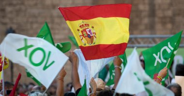 Spanish far-right party Vox supporters wave flags during a campaign meeting in Mallorca, Spain, July 14, 2023. (AFP Photo)