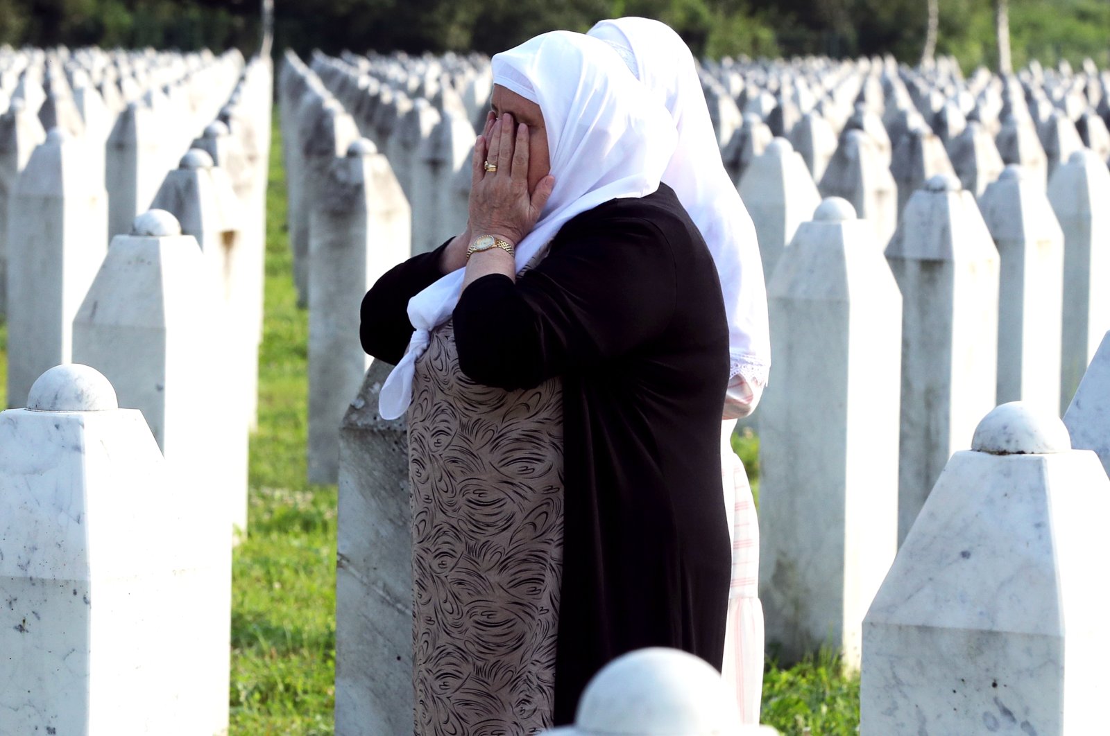 A Bosnian Muslim woman weeps during a funeral ceremony for 30 newly identified Muslim Bosnian victims, at the Potocari Memorial Center and Cemetery, in Srebrenica, Bosnia-Herzegovina, July 11, 2023. (EPA Photo)