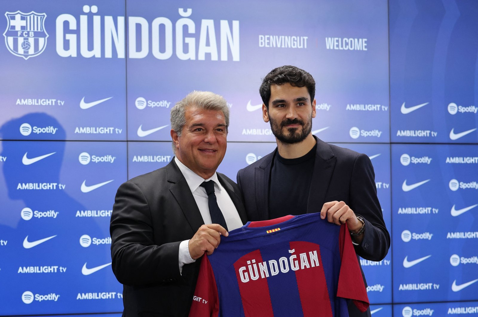 FC Barcelona&#039;s newly-signed German midfielder Ilkay Gundogan (R) poses for pictures with FC Barcelona&#039;s President Joan Laporta holding his jersey during his official presentation at the Joan Gamper training ground in Sant Joan Despi, Barcelona, Spain, July 17, 2023. (AFP Photo)