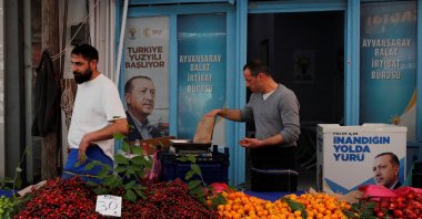 Vendors stand in their stall outside a local office of President Tayyip Erdoğan's ruling Justice and Development Party (AK Party), ahead of the May 28 runoff vote, at a fresh market in Istanbul, Türkiye, May 23, 2023. (Reuters Photo)