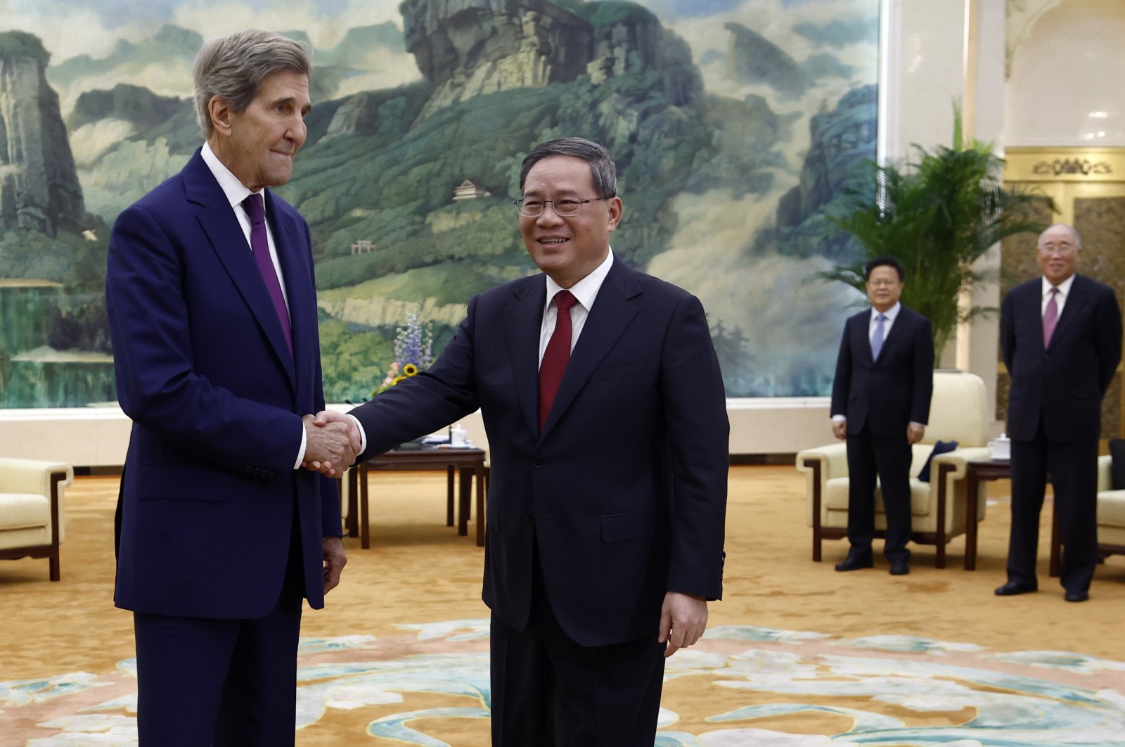 U.S. Special Presidential Envoy for Climate John Kerry (L) and Chinese Premier Li Qiang (R) shake hands in Beijing, China, July 18, 2023. (EPA Photo)