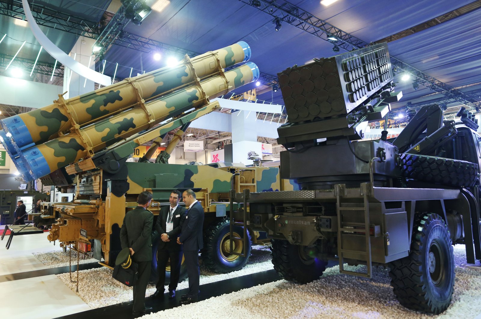 Visitors of the IDEF, the International Defense Industry Fair in Istanbul, talk next to Turkish-made rocket launchers, Wednesday, May 10, 2017. (AP File Photo)