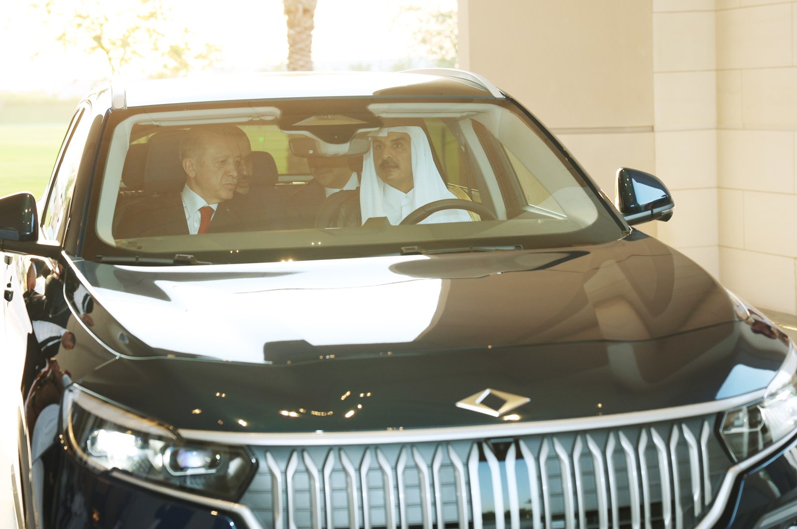 President Recep Tayyip Erdoğan (L) and Qatari Emir Sheikh Tamim bin Hamad Al Thani inside a Togg vehicle in Doha, Qatar, Tuesday, July 18, 2023. (IHA Photo)