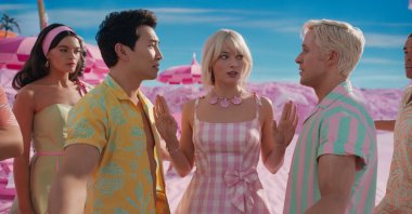 A still shot from "Barbie" shows Barbies and Kens. (Photo courtesy of Warner Bros)