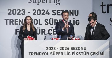 A Turkish Football Federation (TFF) official holds a number during the Turkish Süper Lig fixtures draw, Istanbul, Türkiye, July 18, 2023. (AA Photo)