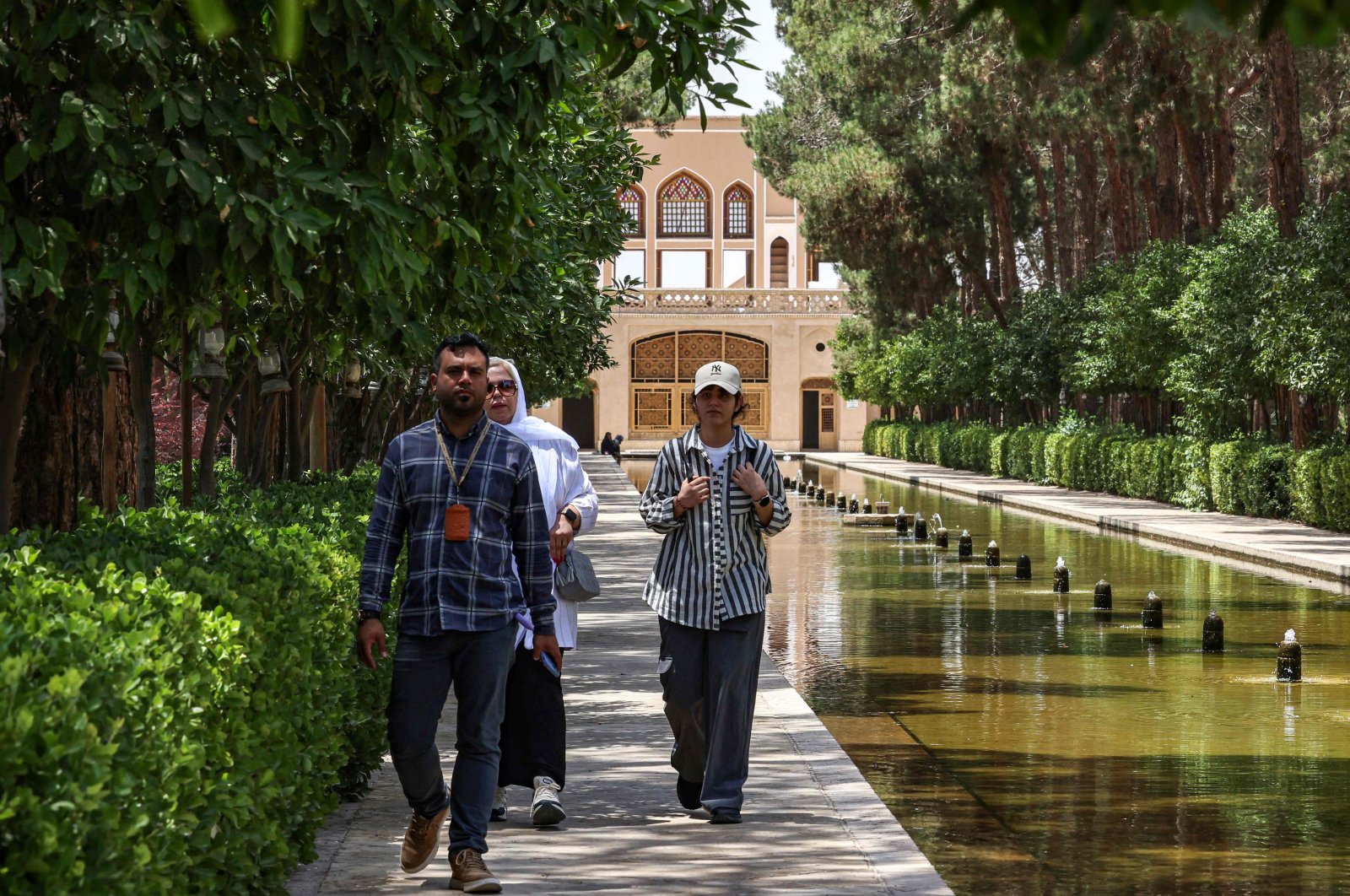 A guide leads tourists at the Dowlat Abad Garden in Iran&#039;s central city of Yazd, Iran, July 3, 2023. (AFP Photo)