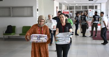 Officials carry completed exams to be evaluated, Istanbul, Türkiye, July 20, 2023. (AA Photo)