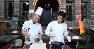 History teacher Zeynep Olgun (R) prepares vegan versions of traditional dishes, in Diyarbakır, Türkiye, July 17, 2023. (AA Photo)