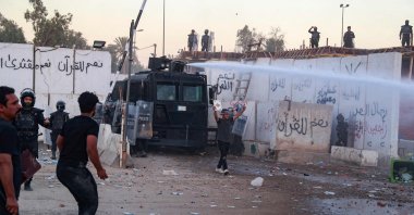 Iraqi riot police use water cannon to disperse protesters outside the Swedish embassy in Baghdad, Iraq, July 20, 2023. (AFP Photo)