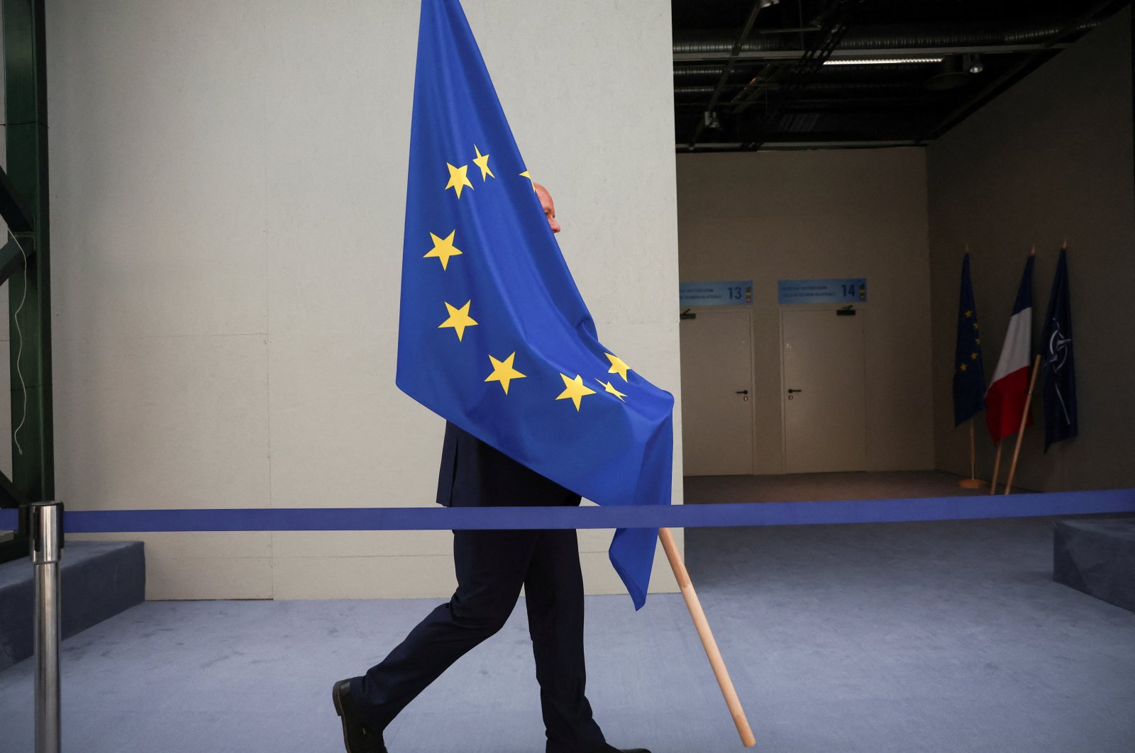 A person carries the EU flag during a NATO leaders summit in Vilnius, Lithuania, July 12, 2023. (Reuters Photo)