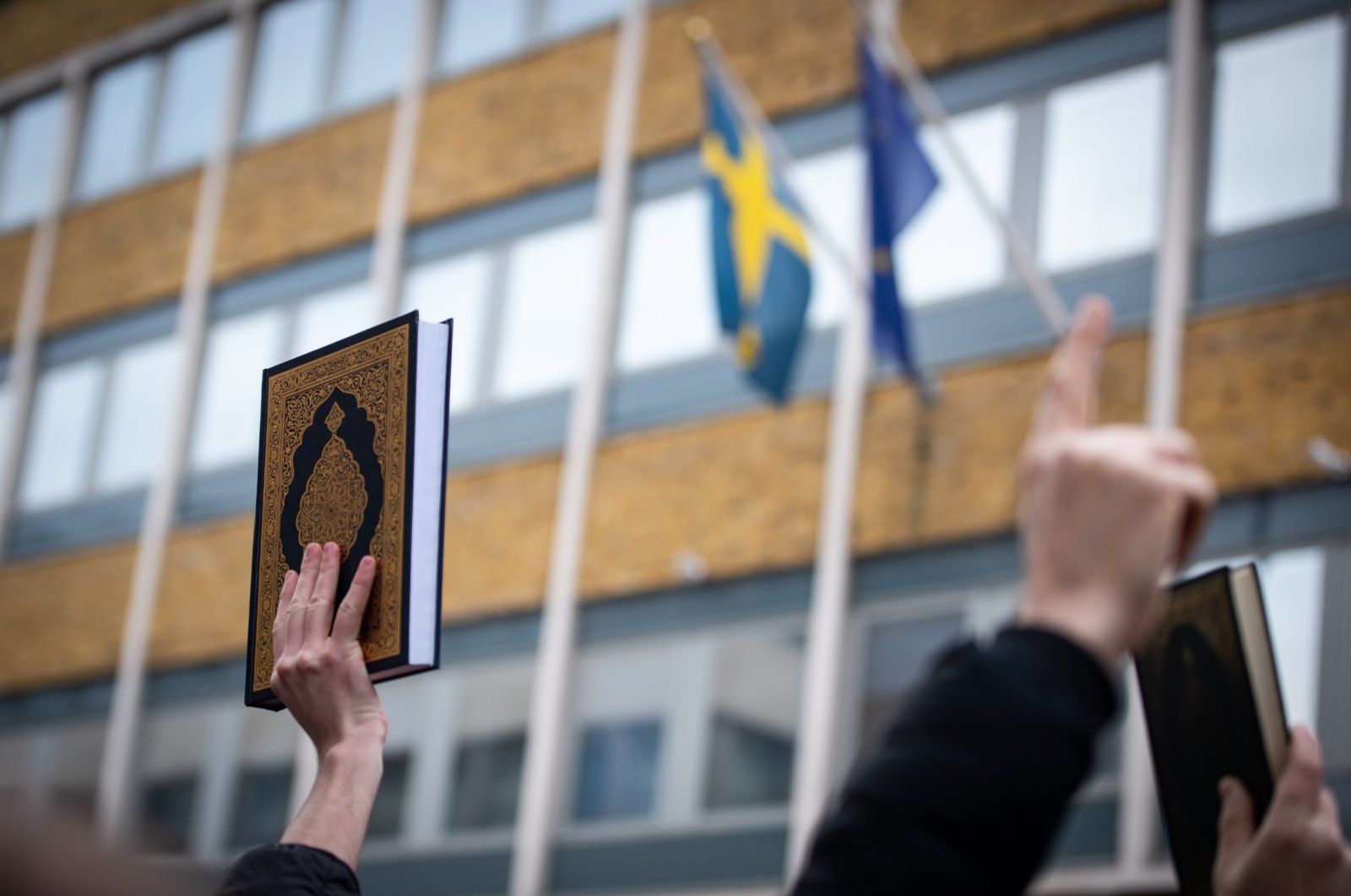 Protestors raise the Quran during the demonstration against the Quran Burning In Sweden, January 27, 2023. (Reuters File Photo)